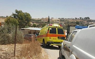 A Magen David Adom ambulance at the site where two children died after being left in a car, in the Al Kaum Regional Council in the Negev, June 22, 2016. (Magen David Adom)