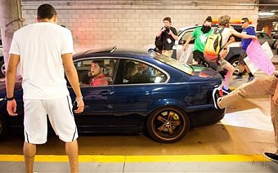 Protesters against Republican presidential candidate Donald Trump kick and jump on a car leaving a Trump campaign rally on Thursday, June 2, 2016, in San Jose, Calif. (AP Photo/Noah Berger) Protesters against Republican presidential candidate Donald Trump kick and jump on a car leaving a Trump campaign rally on Thursday, June 2, 2016, in San Jose, Calif. (AP Photo/Noah Berger)