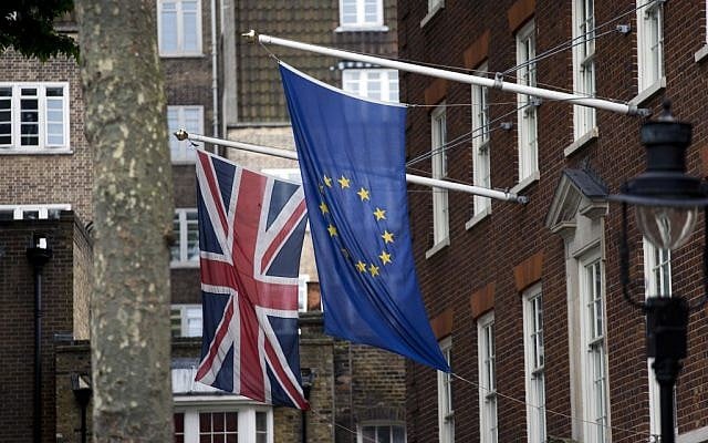 A European, right, and Union flags are displayed outside Europe House, the European Parliament's British offices, in London, Wednesday, June 22, 2016. Britain votes whether to stay in the European Union in a referendum on Thursday. (AP Photo/Matt Dunham)