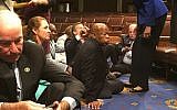 This photo provided by Rep. John Yarmuth, D-Ky., shows Democrat members of Congress, including Rep. John Lewis, D-Ga., center, and Rep. Joe Courtney, D-Conn., left, participate in sit-down protest seeking a a vote on gun control measures, Wednesday, June 22, 2016, on the floor of the House on Capitol Hill in Washington. (Rep. John Yarmuth via AP)