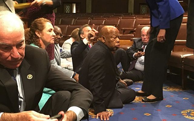 This photo provided by Rep. John Yarmuth, D-Ky., shows Democrat members of Congress, including Rep. John Lewis, D-Ga., center, and Rep. Joe Courtney, D-Conn., left, participate in sit-down protest seeking a a vote on gun control measures, Wednesday, June 22, 2016, on the floor of the House on Capitol Hill in Washington. (Rep. John Yarmuth via AP) This photo provided by Rep. John Yarmuth, D-Ky., shows Democrat members of Congress, including Rep. John Lewis, D-Ga., center, and Rep. Joe Courtney, D-Conn., left, participate in sit-down protest seeking a a vote on gun control measures, Wednesday, June 22, 2016, on the floor of the House on Capitol Hill in Washington. (Rep. John Yarmuth via AP)