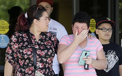Family members of victims of the Pulse nightclub shooting walk out of the Orlando Medical Examiner's Office, Monday, June 13, 2016, in Orlando, Fla. (AP Photo/Alan Diaz)