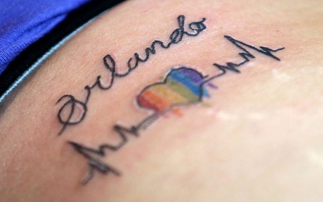 A tattoo showing solidarity with Orlando Pulse is seen on a customer at the Stigma Tattoo parlor, Saturday, June 18, 2016, in Orlando, Fla. Tattoo artists donated their time to draw various designs, and all proceeds will be donated to the victims of the Pulse nightclub mass shootings. (AP/John Raoux)
