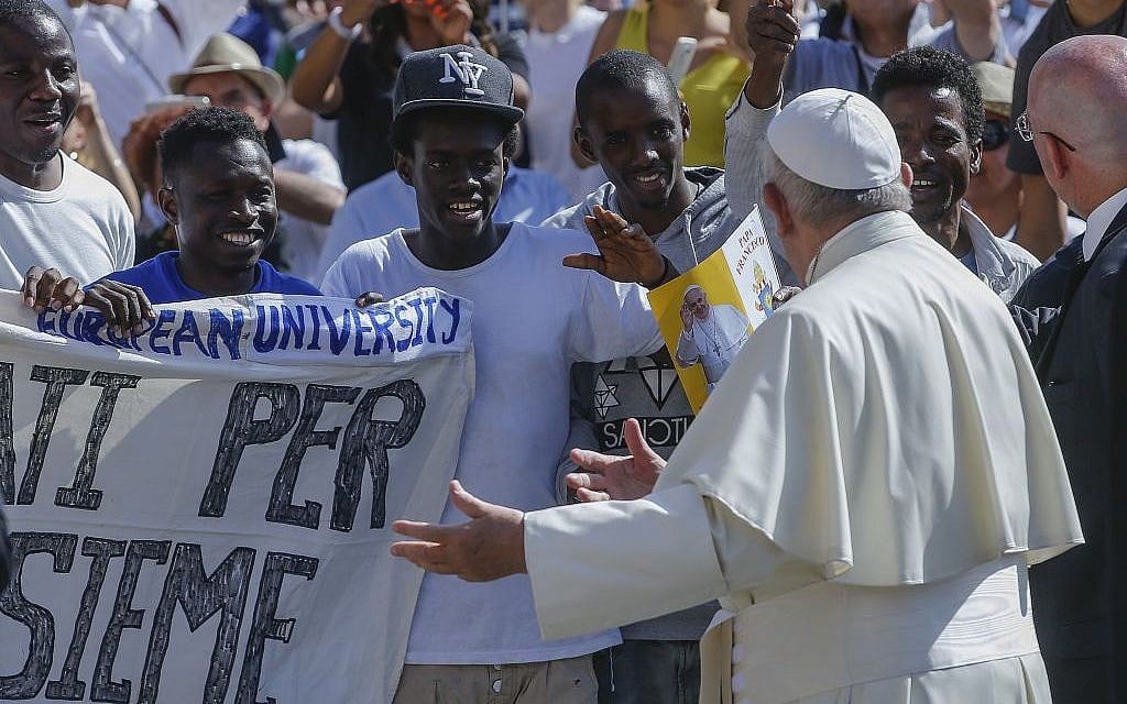 Pope Francis invites a group of refugees to join him on the steps of St. Peter’s Basilica during his weekly general audience in St. Peter's Square at the Vatican, June 22, 2016. (AP Photo/Fabio Frustaci)