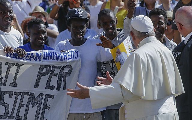 Pope Francis invites a group of refugees to join him on the steps of St. Peter’s Basilica during his weekly general audience in St. Peter's Square at the Vatican, June 22, 2016. (AP Photo/Fabio Frustaci)