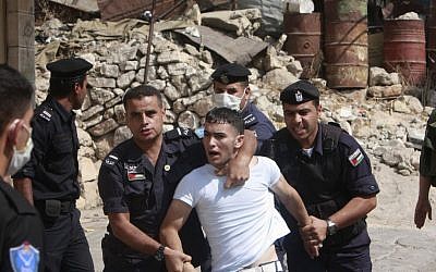 Palestinian police officers detain a Palestinian protester during clashes with Israeli soldiers, not seen, in the West Bank city of Hebron, Wednesday, Sept. 21, 2011 (AP Photo/Nasser Shiyoukhi)