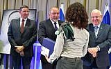 Defense Minister Avigdor Liberman awards an unnamed Military Intelligence officer with the Israel Defense Prize, alongside President Reuven Rivlin and Director-General of the Defense Ministry Udi Adam, left, during a ceremony at the President's Residence in Jerusalem on June 28, 2016. (Ariel Hermoni/Defense Ministry)