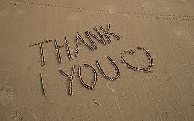A Thank You is written in the sands of Omaha beach next to the Colleville American military cemetery, in Colleville sur Mer, western France, Sunday June 5, 2016. (AP Photo/Francois Mori)