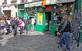 Yomi Peretz, right, approaching a line of tourists waiting to place their orders at The Falafel Ace in the historic Jewish quarter of Paris, April 2012. (WikiMedia Commons)