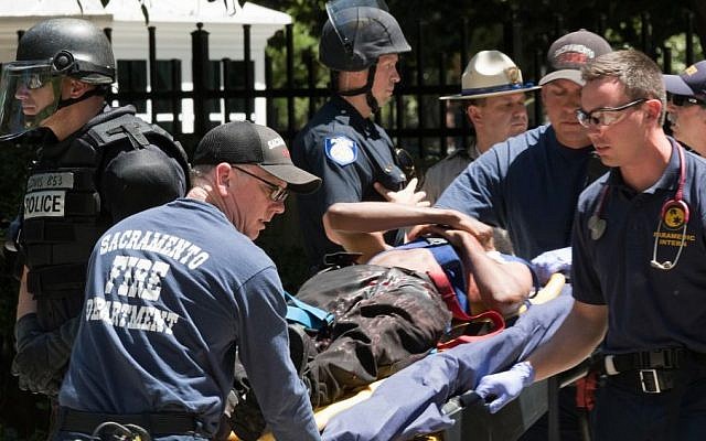 Paramedics rush a stabbing victim away on a gurney Sunday, June 26, 2016, after members of right-wing extremists groups holding a rally outside the California state Capitol building in Sacramento clashed with counter-protesters, authorities said. (AP/Steven Styles) Paramedics rush a stabbing victim away on a gurney Sunday, June 26, 2016, after members of right-wing extremists groups holding a rally outside the California state Capitol building in Sacramento clashed with counter-protesters, authorities said. (AP/Steven Styles)