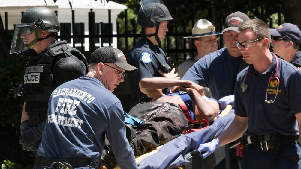 Paramedics rush a stabbing victim away on a gurney Sunday, June 26, 2016, after members of right-wing extremists groups holding a rally outside the California state Capitol building in Sacramento clashed with counter-protesters, authorities said. (AP/Steven Styles) Paramedics rush a stabbing victim away on a gurney Sunday, June 26, 2016, after members of right-wing extremists groups holding a rally outside the California state Capitol building in Sacramento clashed with counter-protesters, authorities said. (AP/Steven Styles)