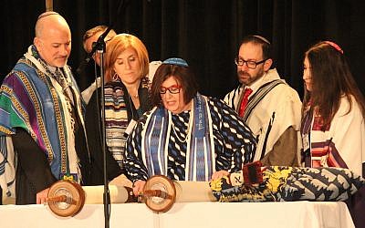 Rabbi Denise Eger, center, reading Torah during her installation as president of the Central Conference of American Rabbis, March 16, 2015. (David A.M. Wilensky)