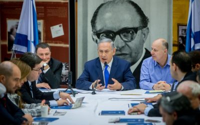 Benjamin Netanyahu, center, holds a Likud faction meeting in front of a photo of former party leader Menachem Begin at the Begin Heritage Center in Jerusalem on March 14, 2016. (Yonatan Sindel/Flash90)