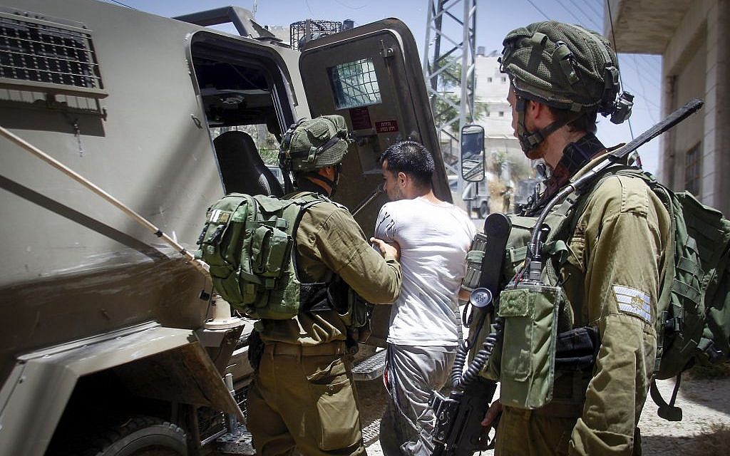 Illustrative. Israeli security forces arrest a Palestinian man after he allegedly threw a Molotov cocktail in the West Bank city of Hebron on June 1, 2016. (Wisam Hashlamoun/Flash90)
