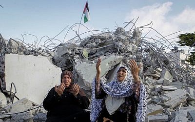 Family members of Palestinian terrorist Morad Adais are seen in the rubble of their house after it was demolished by Israeli forces in the West Bank village of Yatta, south of Hebron, on June 11, 2016. (Wisam Hashlamoun/Flash90) Family members of Palestinian terrorist Morad Adais are seen in the rubble of their house after it was demolished by Israeli forces in the West Bank village of Yatta, south of Hebron, on June 11, 2016. (Wisam Hashlamoun/Flash90)