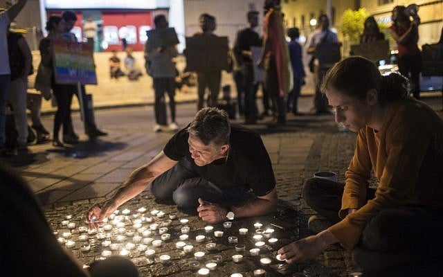 Young Israeli LGBT activists light candles as they gather at Zion Square in Jerusalem in solidarity with the victims of the shooting attack (Hadas Parush/Flash90) Young Israeli LGBT activists light candles as they gather at Zion Square in Jerusalem in solidarity with the victims of the shooting attack (Hadas Parush/Flash90)