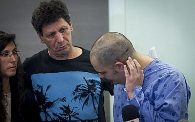 Assaf Bar, who was injured in a shooting attack at the Sarona market in Tel Aviv a few days ago, seen with his family as he speaks to press at Ichilov hospital in Tel Aviv, on June 13, 2016. (Miriam Alster/Flash90)