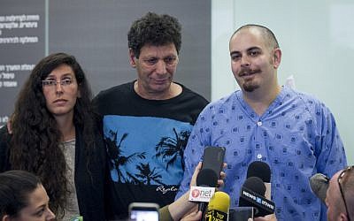 Assaf Bar, who was injured in a shooting attack at the Sarona market in Tel Aviv a few days ago, seen with his family as he speaks to press at Ichilov hospital in Tel Aviv, on June 13, 2016. (Miriam Alster/Flash90)