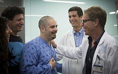 Assaf Bar, who was injured in a shooting attack at the Sarona market in Tel Aviv a few days ago, seen with his family as he speaks to press at Ichilov hospital in Tel Aviv, on June 13, 2016. (Miriam Alster/Flash90)
