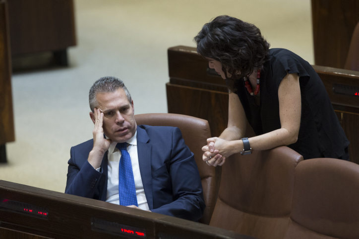 Knesset Member Tamar Zandberg speaks with Public Security Minister Gilad Erdan at the plenary session at the Knesset on June 13, 2016. (Noam Revkin-Fenton/Flash90)