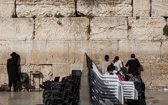 People pray on either side of the dividing wall that separates the male and female prayer sections at the Western Wall, June 14, 2016. (Wajsgras/Flash90) People pray on either side of the dividing wall that separates the male and female prayer sections at the Western Wall, June 14, 2016. (Wajsgras/Flash90)