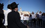 Ultra-Orthodox Jewish men yell and protest the Reform and Conservative Jewish men and women as they hold a prayer service in front of the Western Wall, in Jerusalem's Old City, on June 16, 2016. (Hadas Parush/Flash90)