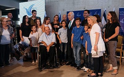 Survivors of Operation Thunderbolt, the Israeli rescue of over 100 hostages from the Entebbe Airport in Uganda on July 4, 1976, along with former Israeli president Shimon Peres and Dalia Rabin, a former member of Knesset and daughter of former prime minister Yitzchak Rabin, present Sorin Hershko with a certificate of appreciation during an event at the Peres Center for Peace in Jaffa marking 40 years since the kidnapping, on June 27, 2016. (Ben Kelmer/FLASH90)