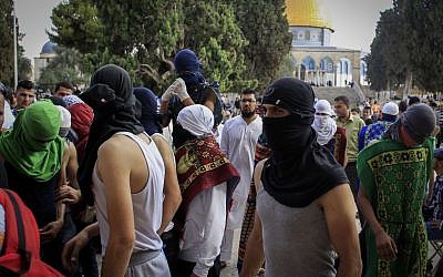 Masked Palestinians hold stones during clashes with Israeli police on the Temple Mount complex in Jerusalem's Old City, June 28, 2016. (Muammar Awad/Flash90) Masked Palestinians hold stones during clashes with Israeli police on the Temple Mount complex in Jerusalem's Old City, June 28, 2016. (Muammar Awad/Flash90)