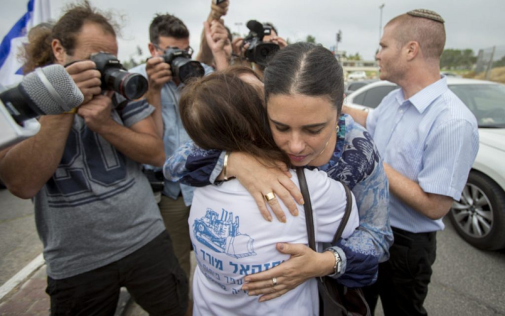 Justice Minister Ayelet Shaked hugs the mother of late Israeli soldier Oron Shaul outside the Prime Minister's Office during a protest against the agreement with Turkey outside the cabinet meeting, in Jerusalem, June 29, 2016. (Yonatan Sindel/Flash90)