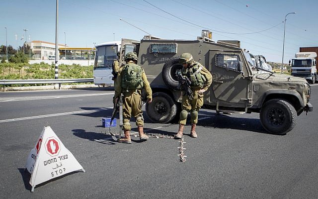 Israeli soldiers set up a checkpoint at the entrance to the Kiryat Arba settlement in the West Bank on June 30, 2016, after a Palestinian teenager stabbed and killed a 13-year-old Israeli girl there. (Wisam Hashlamoun/Flash90) Israeli soldiers set up a checkpoint at the entrance to the Kiryat Arba settlement in the West Bank on June 30, 2016, after a Palestinian teenager stabbed and killed a 13-year-old Israeli girl there. (Wisam Hashlamoun/Flash90)