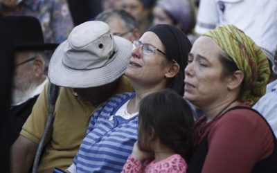 The family of Hallel Yaffa Ariel mourn during her funeral ceremony in the Jewish settlement of Kiryat Arba, in the West Bank, on June 30, 2016. Earlier in the day, a 17-year-old Palestinian terrorist broke into their home and stabbed and killed 13-year-old Hallel as she slept in her bedroom. (Yonatan Sindel/Flash90)