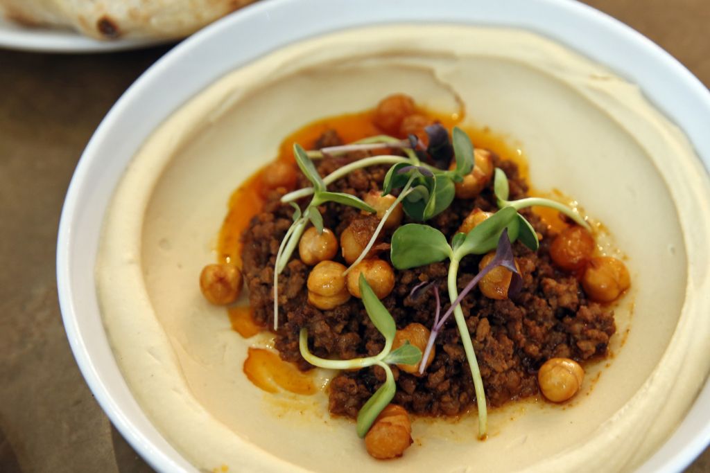 In this Tuesday, May 31, 2016 photo, lamb ragu hummus with crispy chickpeas, sits on a table at Shaya Restaurant, in New Orleans. (AP Photo/Gerald Herbert) In this Tuesday, May 31, 2016 photo, lamb ragu hummus with crispy chickpeas, sits on a table at Shaya Restaurant, in New Orleans. (AP Photo/Gerald Herbert)