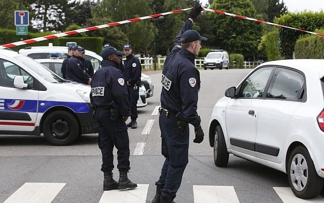 French police officers work at the crime scene the day after a knife-wielding attacker stabbed a senior police officer to death Monday evening outside his home in Magnanville, west of Paris, France, Tuesday, June 14, 2016. (AP Photo/Thibault Camus) French police officers work at the crime scene the day after a knife-wielding attacker stabbed a senior police officer to death Monday evening outside his home in Magnanville, west of Paris, France, Tuesday, June 14, 2016. (AP Photo/Thibault Camus)