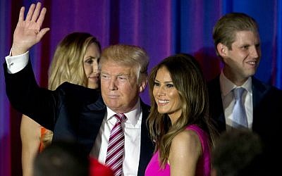 Republican presidential candidate Donald Trump waves at supporters as he leaves the stage with his wife Melania after a news conference at the Trump National Golf Club Westchester, Tuesday, June 7, 2016, in Briarcliff Manor, New York. (AP Photo/Mary Altaffer)