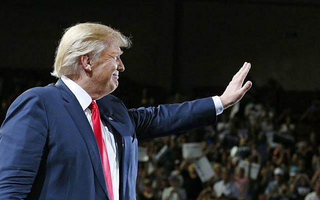 Republican presidential candidate Donald Trump waves to supporters as he arrives to speak at a rally Saturday, June 18, 2016, in Phoenix, Arizona. (AP Photo/Ross D. Franklin)