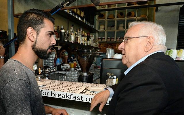 President Reuven Rivlin visit the Sarona Market shopping center in Tel Aviv on June 9, 2016, the morning after a deadly terror attack at the site. (Mark Neiman/GPO)