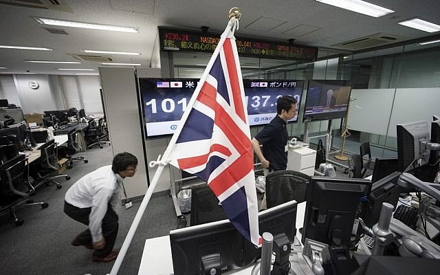 Money traders walk past a flag of the United Kingdom at a foreign exchange brokerage at a securities firm in Tokyo, Friday, June 24, 2016. (AP Photo/Eugene Hoshiko) Money traders walk past a flag of the United Kingdom at a foreign exchange brokerage at a securities firm in Tokyo, Friday, June 24, 2016. (AP Photo/Eugene Hoshiko)