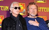 Led Zeppelin guitarist Jimmy Page, left, and singer Robert Plant appear at a press conference ahead of the worldwide theatrical release of "Celebration Day," a concert film of their 2007 London O2 arena reunion show, in New York, October 9, 2012. (Evan Agostini/Invision/AP)