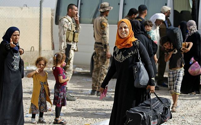 Displaced Iraqi families arrive at an Iraqi army camp after fleeing their homes during fighting between Iraqi security forces and the Islamic State group, outside Fallujah, Iraq, Saturday, June 4, 2016. (AP Photo)