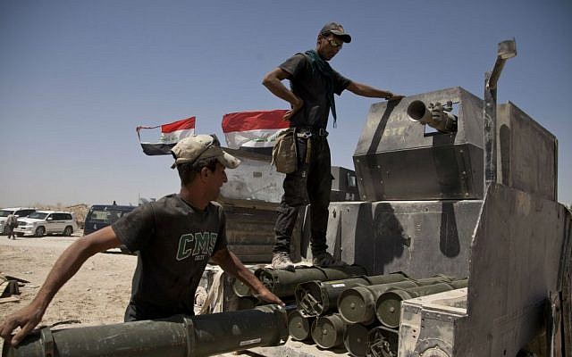 Iraqi counterterrorism forces load a Humvee with rockets to take to a front line position in their fight to oust Islamic State fighters from Fallujah, Iraq, Tuesday, June 7, 2016. (AP Photo/Maya Alleruzzo)