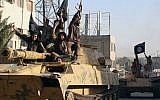 In this undated file image posted by the Raqqa Media Center in Islamic State-held territory, on Monday, June 30, 2014, IS fighters ride tanks during a parade in Raqqa, Syria. (AP Photo/Raqqa Media Center, File)