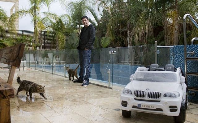 In this March 28, 2016 file photo, Gilbert Chikli, 50, poses for a photo at his home in Ashdod, Israel. (AP Photo/Oded Balilty, File) In this March 28, 2016 file photo, Gilbert Chikli, 50, poses for a photo at his home in Ashdod, Israel. (AP Photo/Oded Balilty, File)