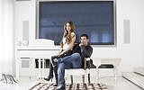 In this March 28, 2016 file photo, Gilbert Chikli, 50, and his wife Shirly Chikli, 31, pose for a photo at their home in Ashdod, Israel. (AP Photo/Oded Balilty, File)