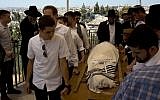 People carry the body of American philanthropist Irving Moskowitz during his funeral in Jerusalem on June 20, 2016. (AP/Sebastian Scheiner)