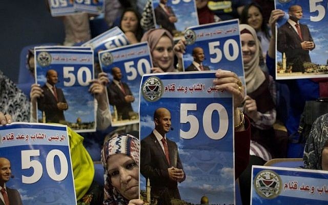 Palestinian fans of Waad Qannam, 24, carry electoral posters with his picture, his voting code, and Arabic that reads "the upcoming president," after announcing him the winner of TV show called "The President," during the finale night, in the West Bank city of Ramallah, Thursday, June 2, 2016. (AP Photo/Nasser Nasser) Palestinian fans of Waad Qannam, 24, carry electoral posters with his picture, his voting code, and Arabic that reads "the upcoming president," after announcing him the winner of TV show called "The President," during the finale night, in the West Bank city of Ramallah, Thursday, June 2, 2016. (AP Photo/Nasser Nasser)