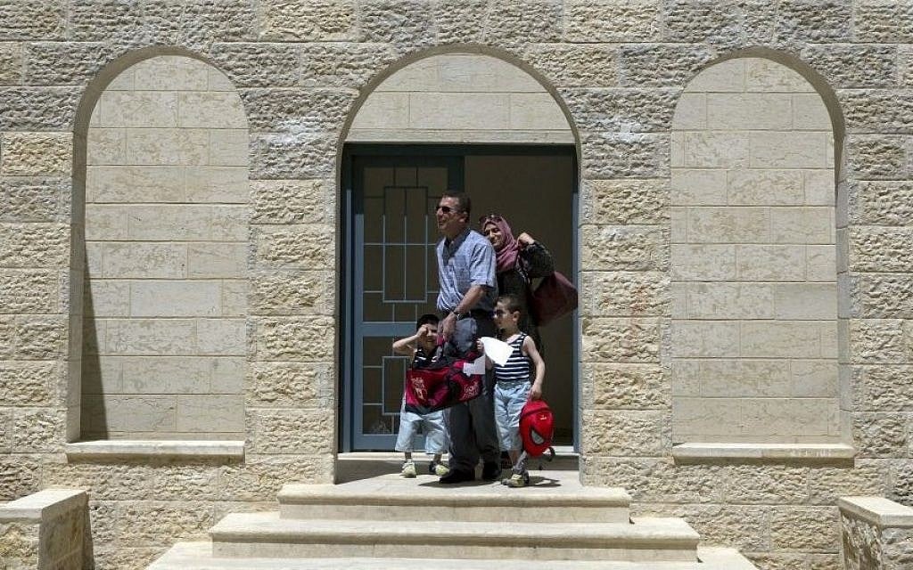 In this June 4, 2016 photo, a Palestinian family leaves their newly delivered apartment in the West Bank city of Rawabi, north of Ramallah. (AP Photo/Nasser Nasser) In this June 4, 2016 photo, a Palestinian family leaves their newly delivered apartment in the West Bank city of Rawabi, north of Ramallah. (AP Photo/Nasser Nasser)