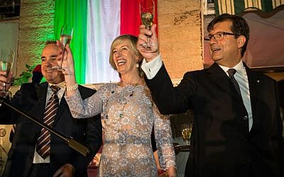 Israeli Minister of Energy Yuval Steinitz (left) raises a glass alongside Italian Minister of Education, Universities, and Research Stefania Giannini and Ambassador Francesco Maria Talò during a Festa della Repubblica celebration at the ambassador's residence in Ramat Gan on June 2, 2016 (Rossella Tercatin/Times of Israel)