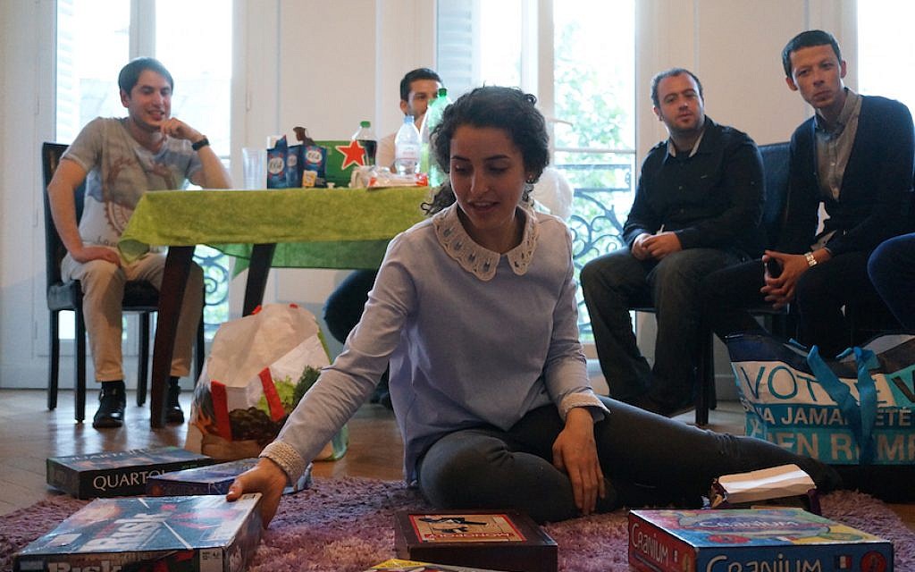 Illustrative: a host showcasing board games for her guests at Moishe House Beaubourg in Paris, May 18, 2016. (JTA/Cnaan Liphshiz) Illustrative: a host showcasing board games for her guests at Moishe House Beaubourg in Paris, May 18, 2016. (JTA/Cnaan Liphshiz)