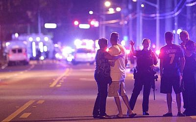 Orlando Police officers direct family members away from a fatal shooting at Pulse Orlando nightclub in Orlando, Florida, June 12, 2016. (AP Photo/Phelan M. Ebenhack, File)