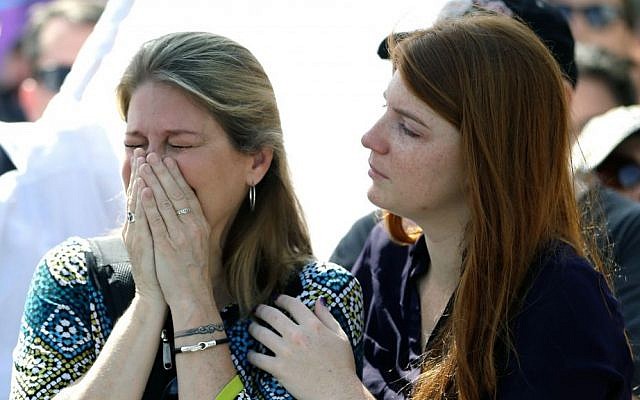 Randa Black, left, cries and is comforted by McKenna Post after seeing demonstrators across the street during a rally to show support and solidarity near the funeral service for Christopher Andrew Leinonen, one of the victims of the Pulse nightclub mass shooting, outside the Cathedral Church of St. Luke, Saturday, June 18, 2016, in Orlando, Florida. (AP Photo/John Raoux) Randa Black, left, cries and is comforted by McKenna Post after seeing demonstrators across the street during a rally to show support and solidarity near the funeral service for Christopher Andrew Leinonen, one of the victims of the Pulse nightclub mass shooting, outside the Cathedral Church of St. Luke, Saturday, June 18, 2016, in Orlando, Florida. (AP Photo/John Raoux)